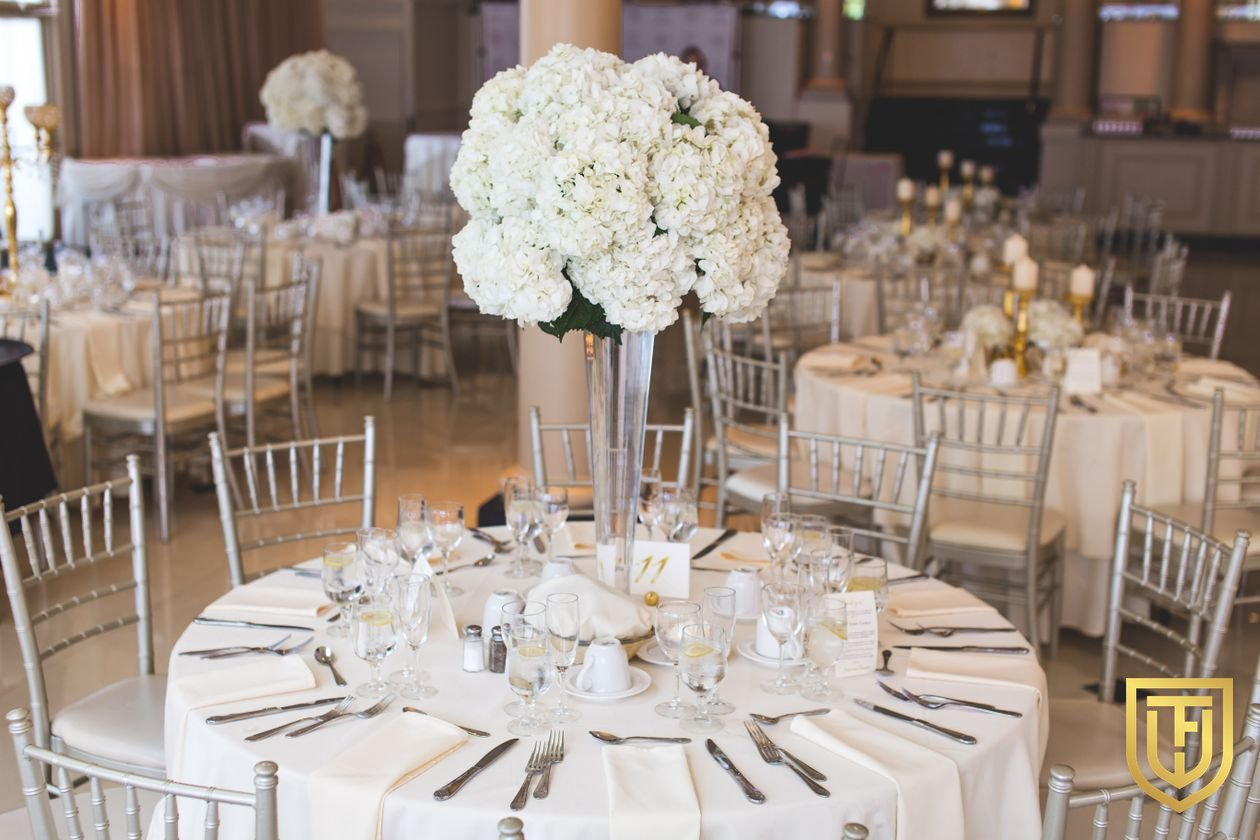 Banquet ballroom set with round tables and centerpieces